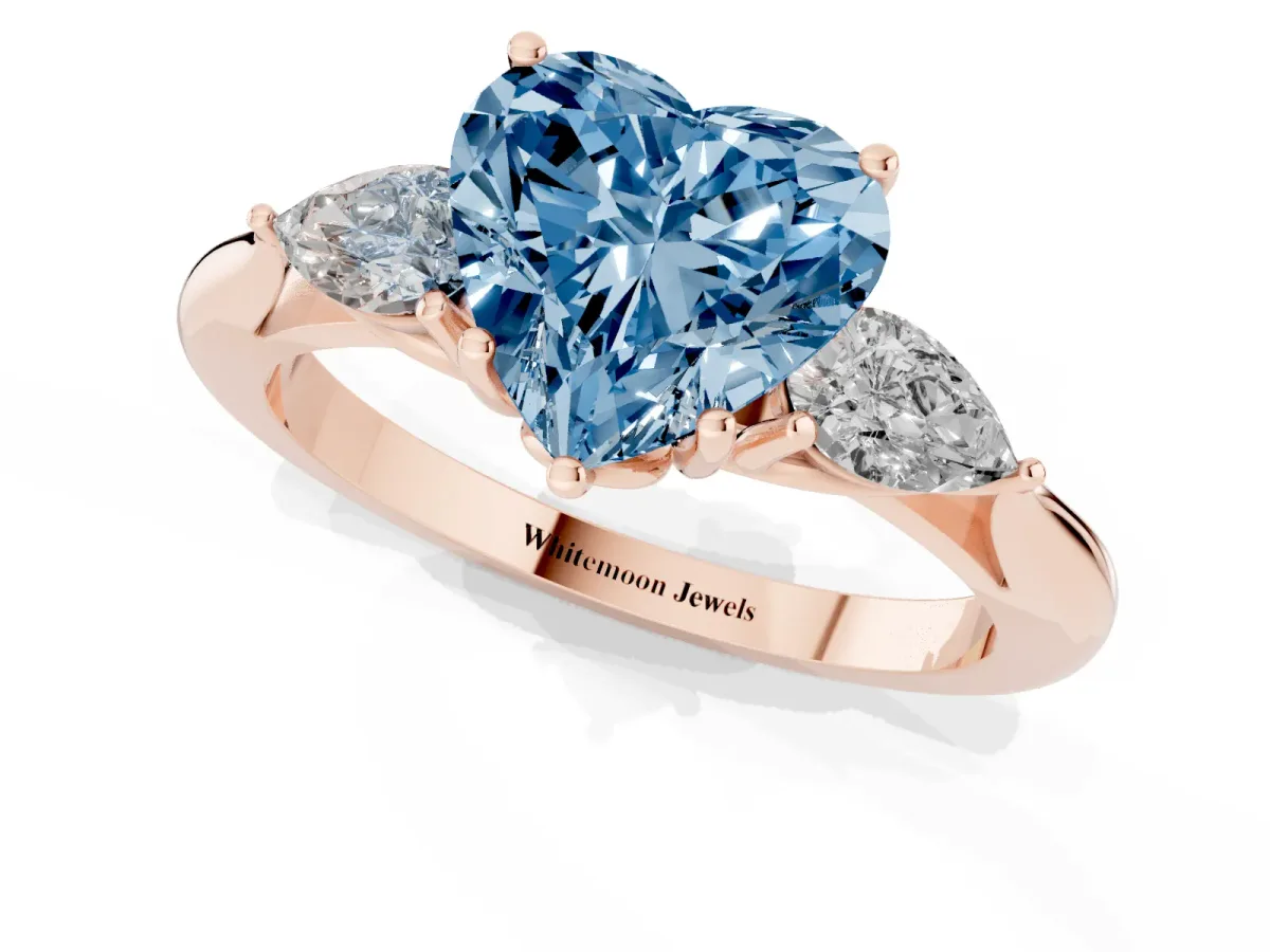 Fancy Blue Three-Stone Heart Cut Brilliant Diamond Solitaire Ring with Tapered Band and Four-Prong Setting Rose gold