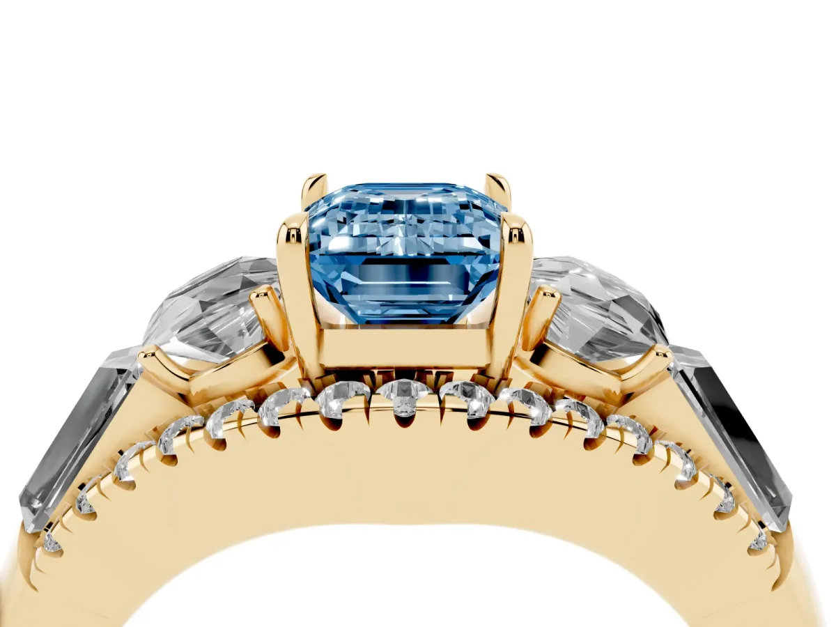 Fancy Blue Three-Stone Emerald Cut Diamond Engagement Ring with Pave Band and Prong Setting Yellow gold