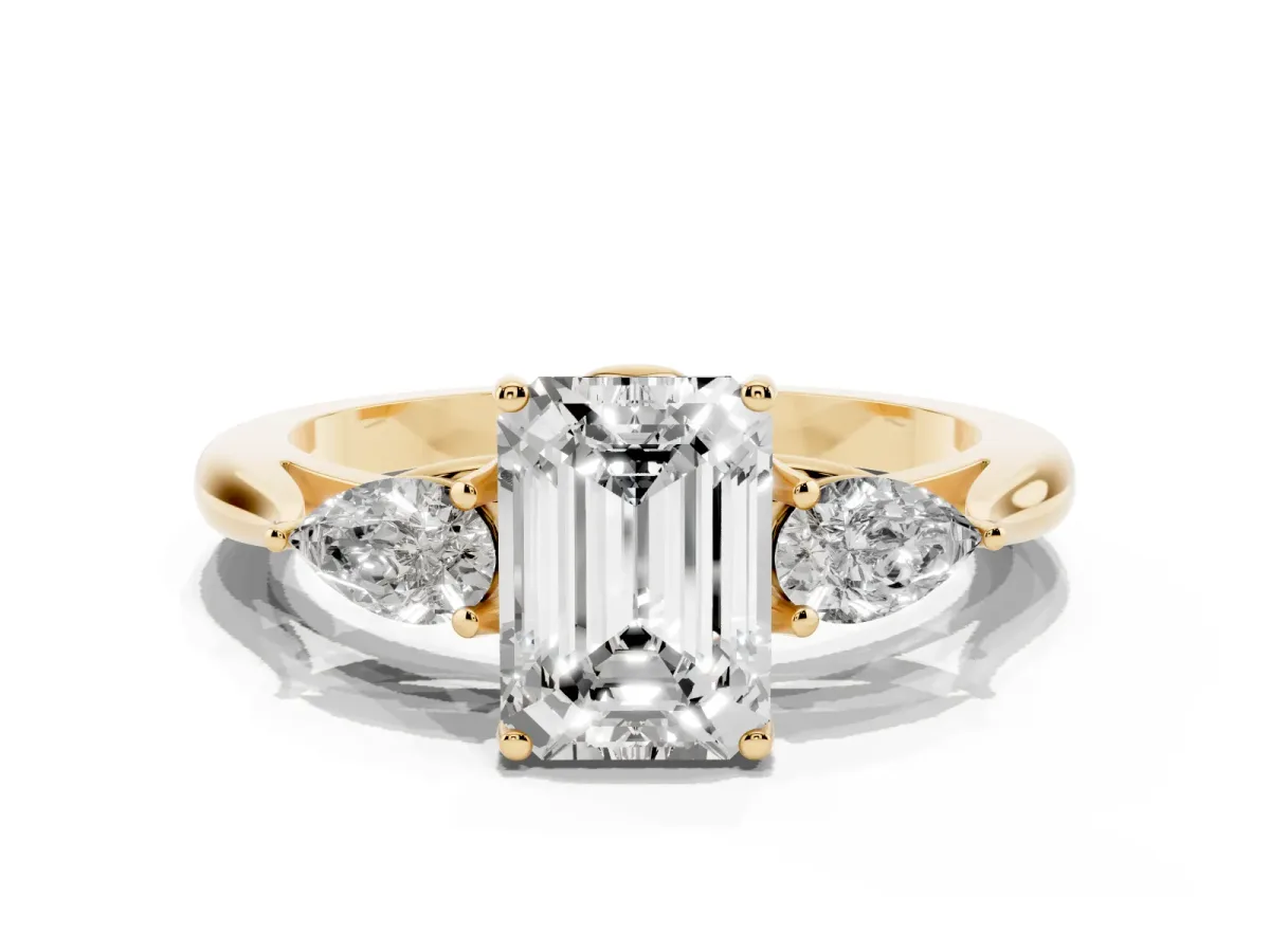 Three-Stone Emerald Cut Brilliant Diamond Solitaire Ring with Tapered Band and Four-Prong Setting Yellow gold