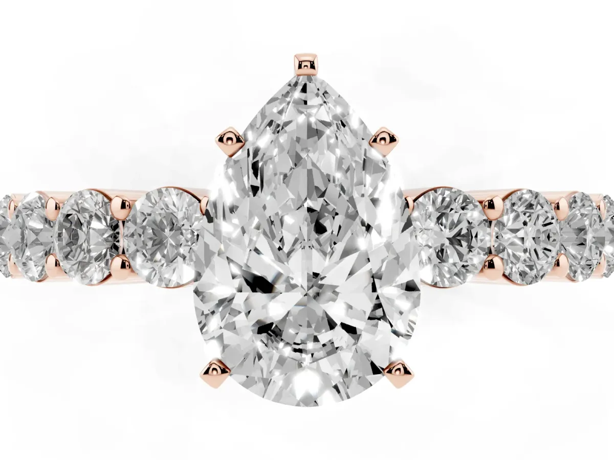 Pear Cut Diamond Solitaire Ring with Shared Prong Round Side Stones Rose gold