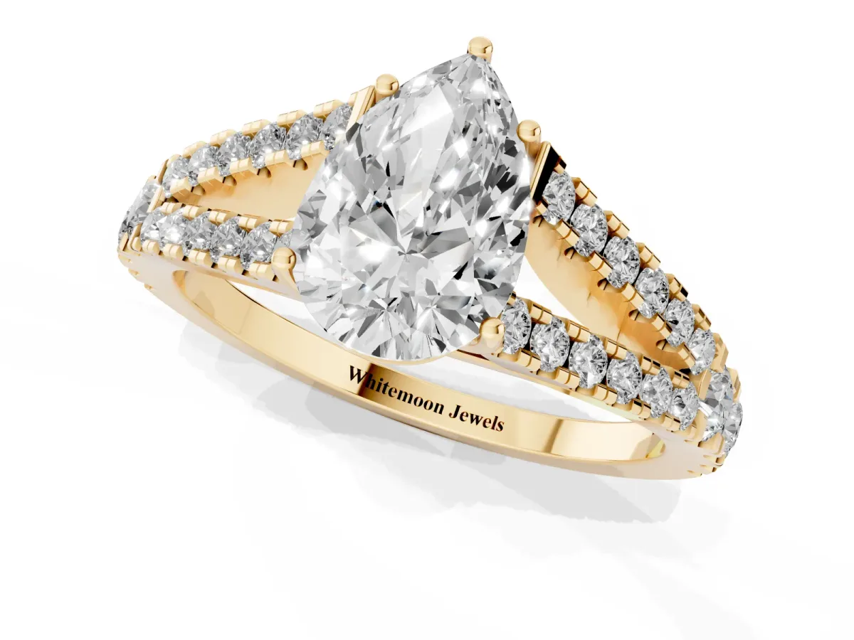 Pear Cut Diamond Split Shank Engagement Ring with Round Pavé and Prong Setting Yellow gold