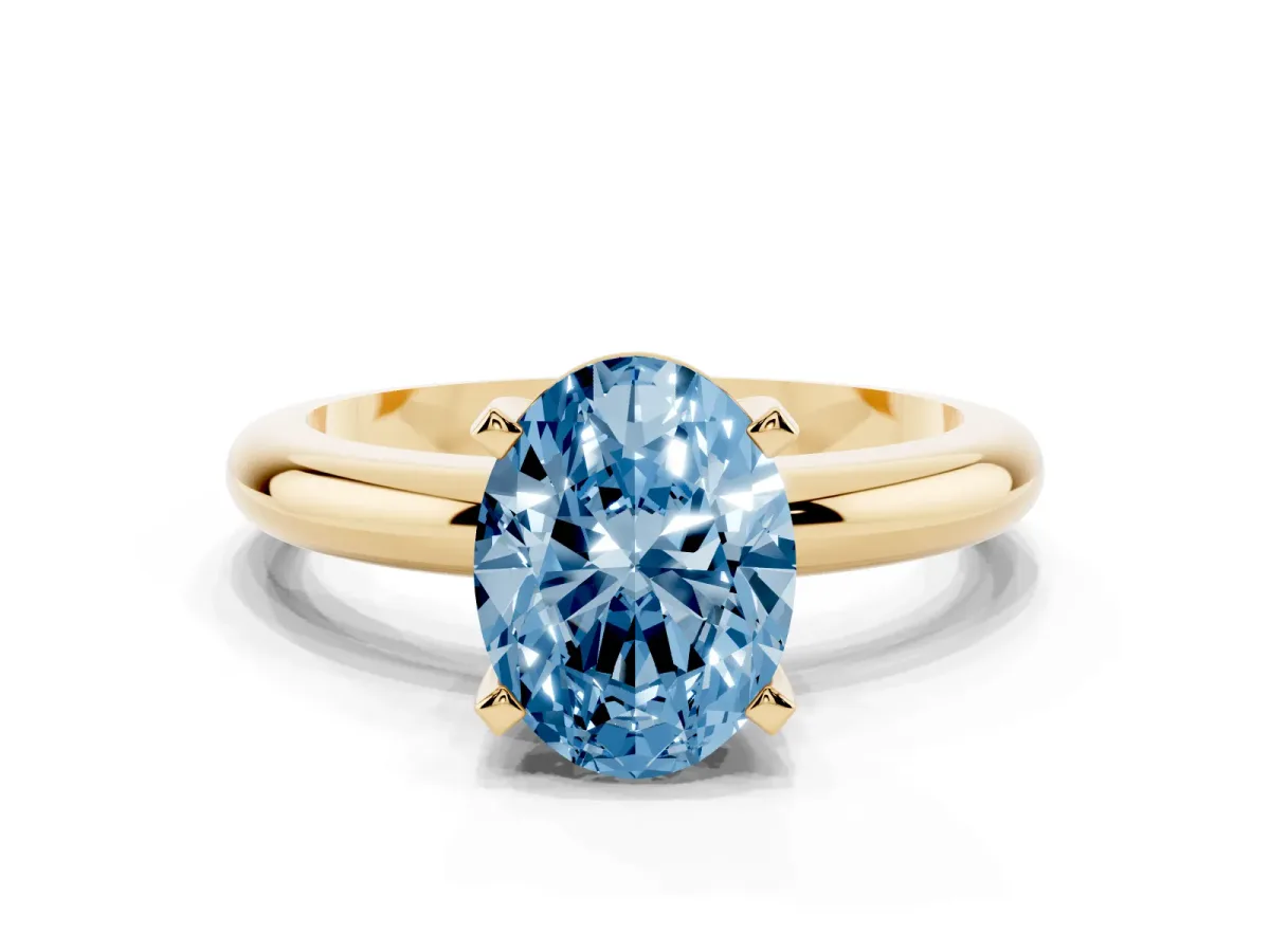 Fancy Blue Oval Cut Diamond Solitaire Engagement Ring with Round Band and Four-Prong Setting Yellow gold