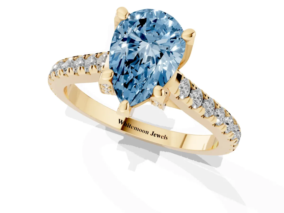 Fancy Blue Pear Cut Brilliant Diamond Solitaire with Pavé Band and Four-Prong Setting Yellow gold