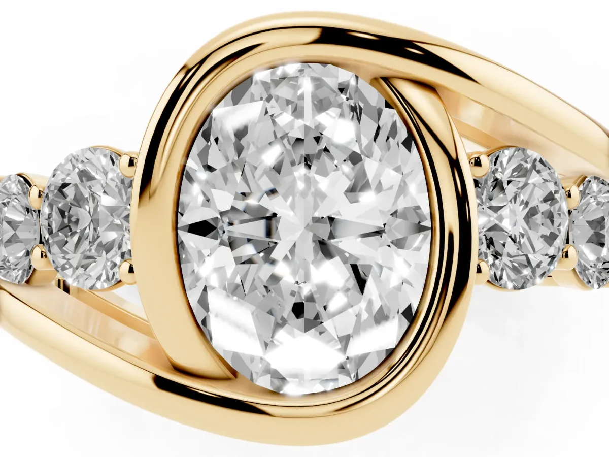 Bezel Set Oval Cut Diamond Bypass Ring with Round Accents Yellow gold