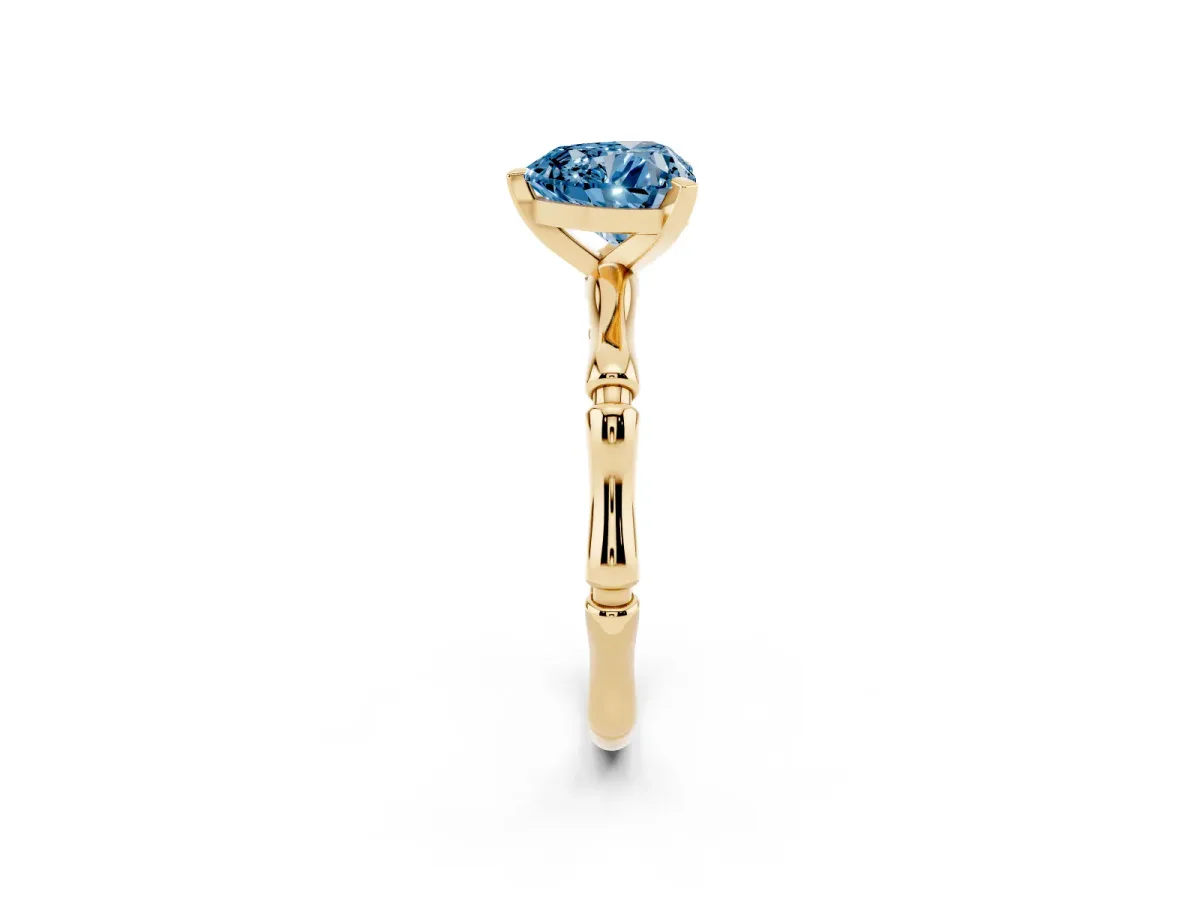 Fancy Blue Heart Cut Solitaire Diamond Ring with Bamboo Band and Four-Prong Setting Yellow gold