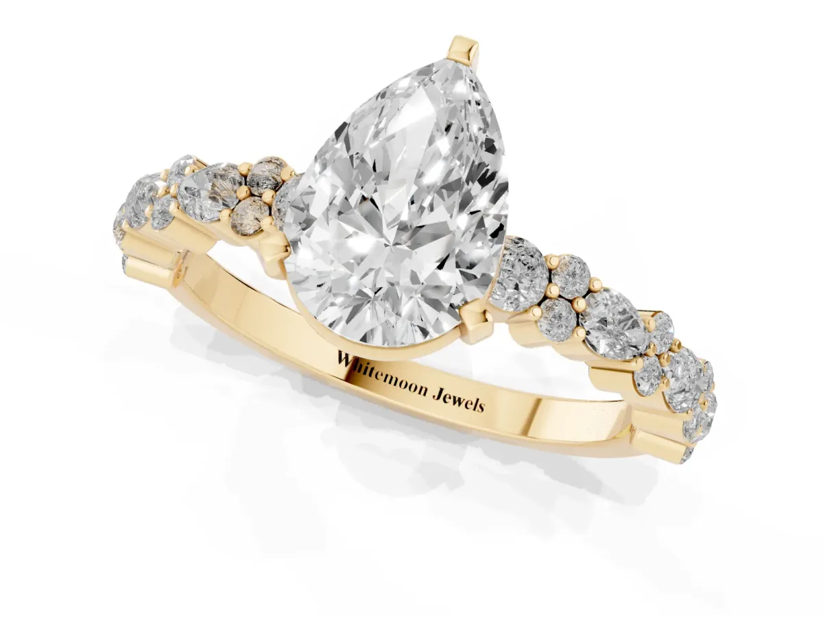 Pear Cut Diamond Side Stone Solitaire Ring with Round and Four-Prong Setting Yellow gold