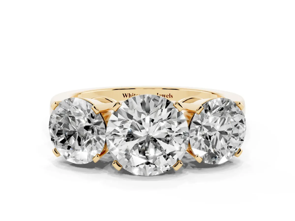 Three-Stone Round Cut Cut Diamond Ring with Channel Set Band and Four-Prong Setting Yellow gold