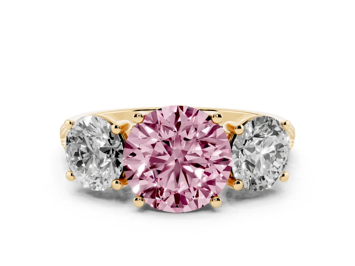 Fancy Pink Three-Stone Round Cut Diamond Ring with Round Pavé Band and Prong Setting Yellow gold