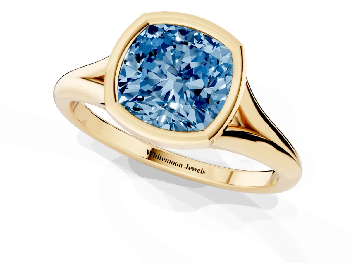Fancy Blue Bezel Set Cushion Cut Cut Solitaire Ring with Tapered Band Yellow gold