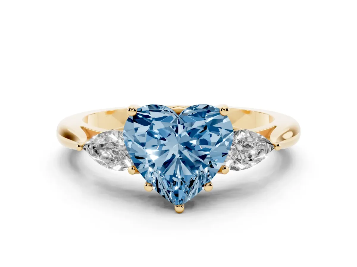 Fancy Blue Three-Stone Heart Cut Brilliant Diamond Solitaire Ring with Tapered Band and Four-Prong Setting Yellow gold