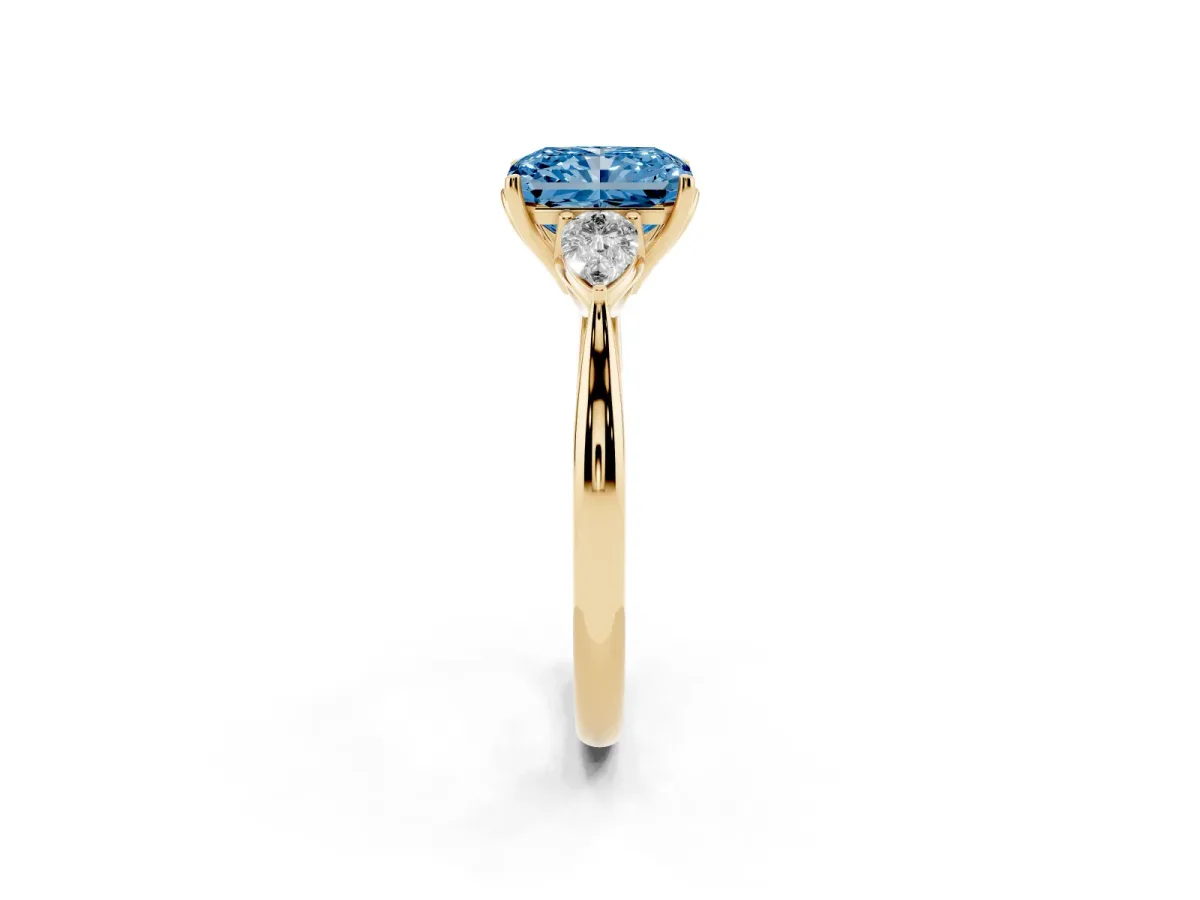 Fancy Blue Radiant Cut Diamond Three-Stone Ring with Pear Side Stones and Prong Setting Yellow gold