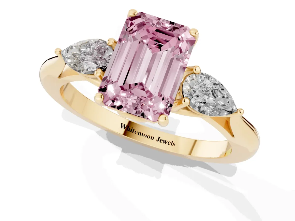 Fancy Pink Three-Stone Emerald Cut Diamond Ring with Pear Side Stones in Four-Prong Setting Yellow gold