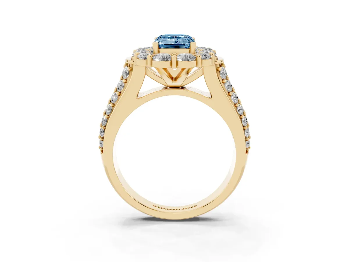 Fancy Blue Emerald Cut Halo Diamond Engagement Ring with Split Shank and Prong Setting Yellow gold