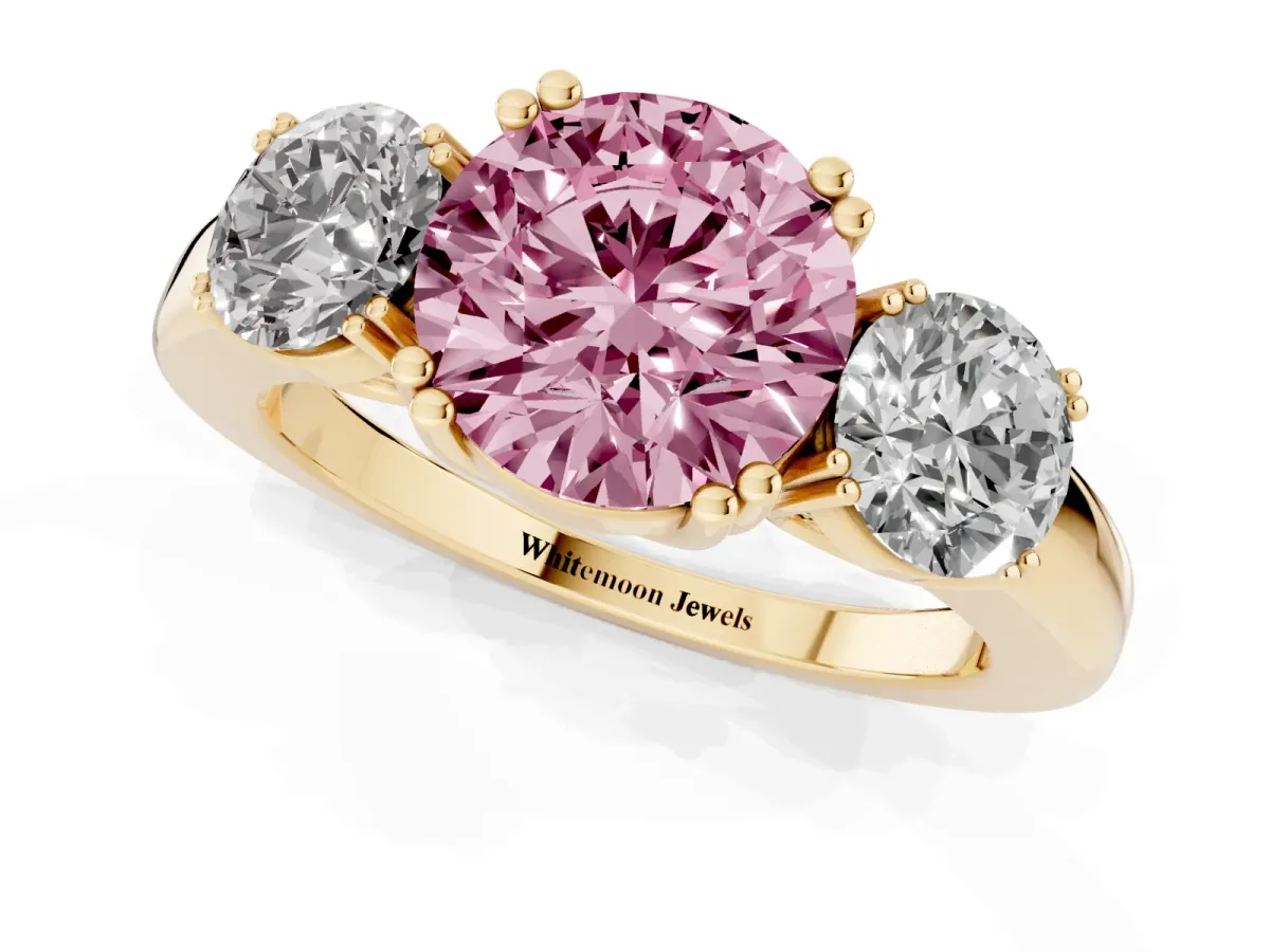 Fancy Pink Three-Stone Round Cut Cut Diamond Ring with Channel Set Band and Four-Prong Setting Yellow gold