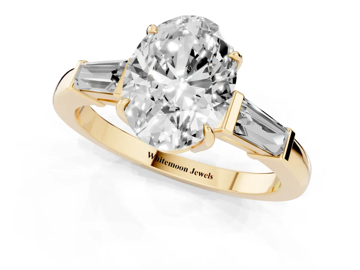Oval Cut Diamond Three-Stone Ring with Tapered Baguette Side Stones and Prong Setting Yellow gold
