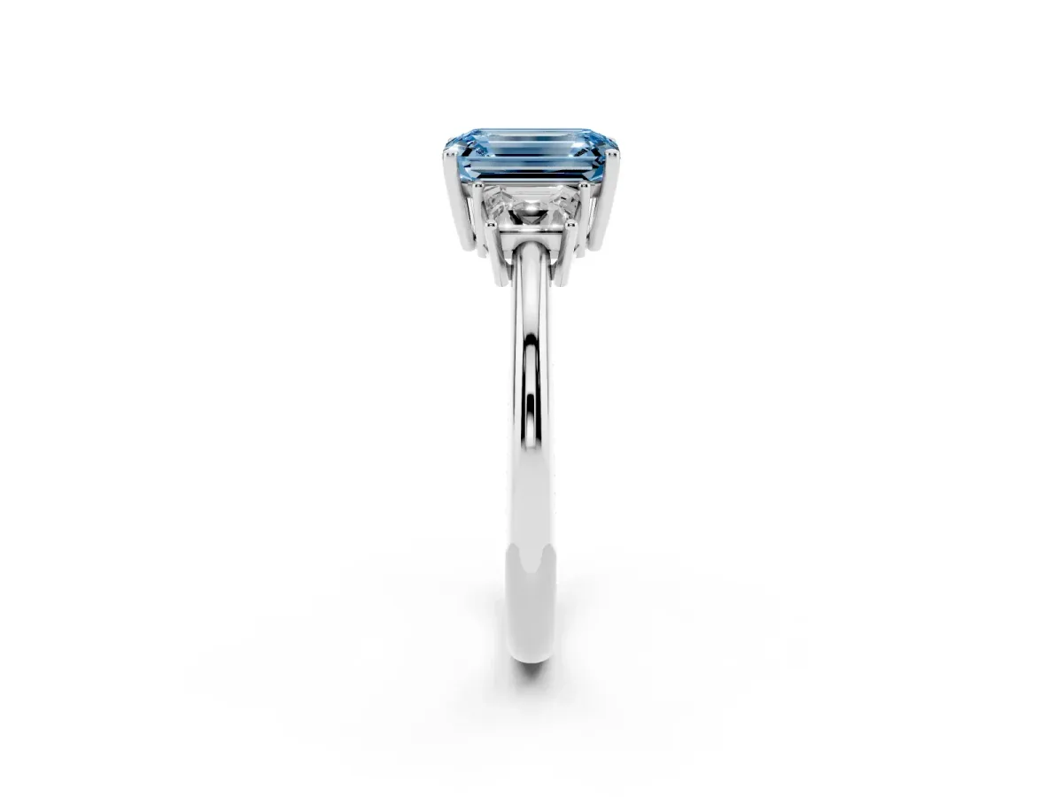 Fancy Blue Emerald Cut Diamond Three-Stone Ring with Trapezoid Side Stones and Prong Setting Platinum