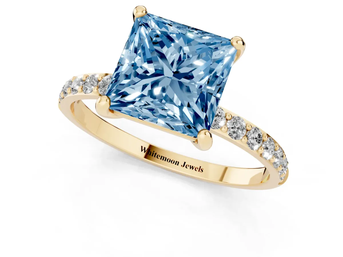Fancy Blue Princess Cut Diamond Solitaire Ring with Round Pavé Band and Prong Setting Yellow gold