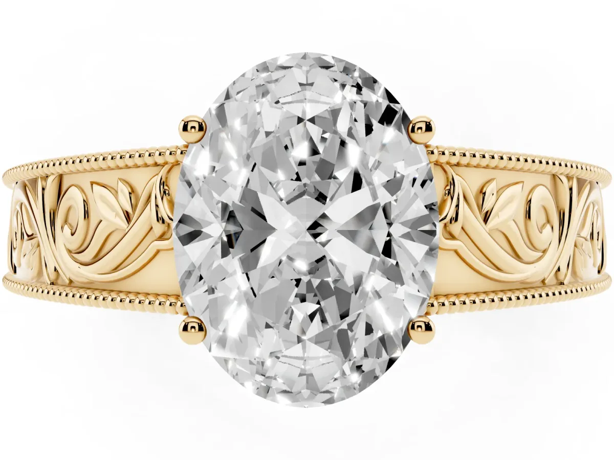 Oval Cut Diamond Solitaire Ring with Engraved Band and Four-Prong Setting Yellow gold