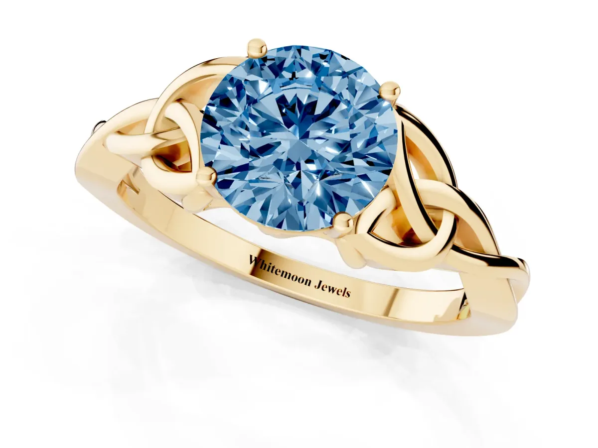 Fancy Blue Round Cut Diamond Solitaire Engagement Ring with Celtic Knot Band and Four-Prong Setting Yellow gold