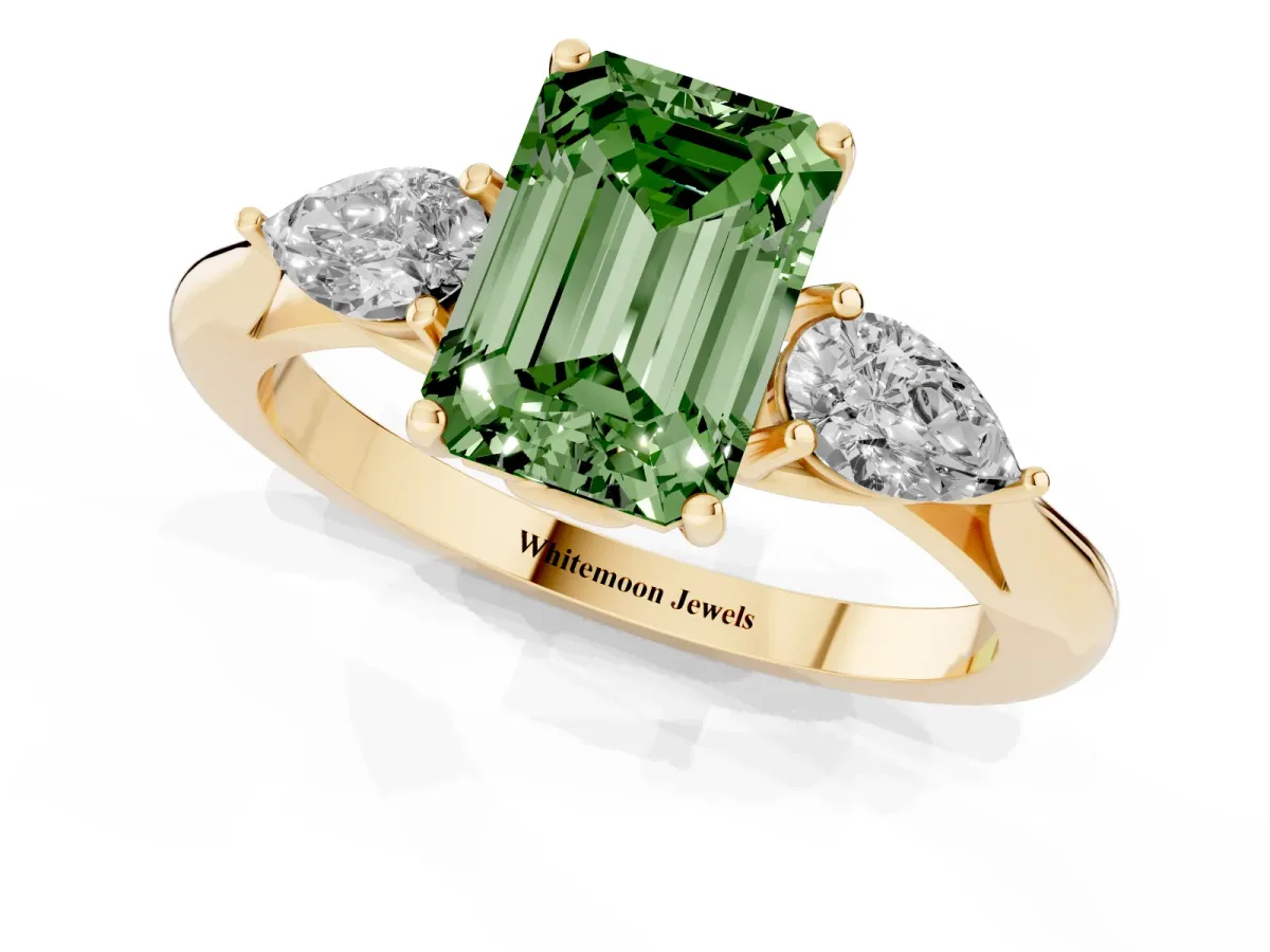 Fancy Green Three-Stone Emerald Cut Diamond Ring with Pear Side Stones in Four-Prong Setting Yellow gold