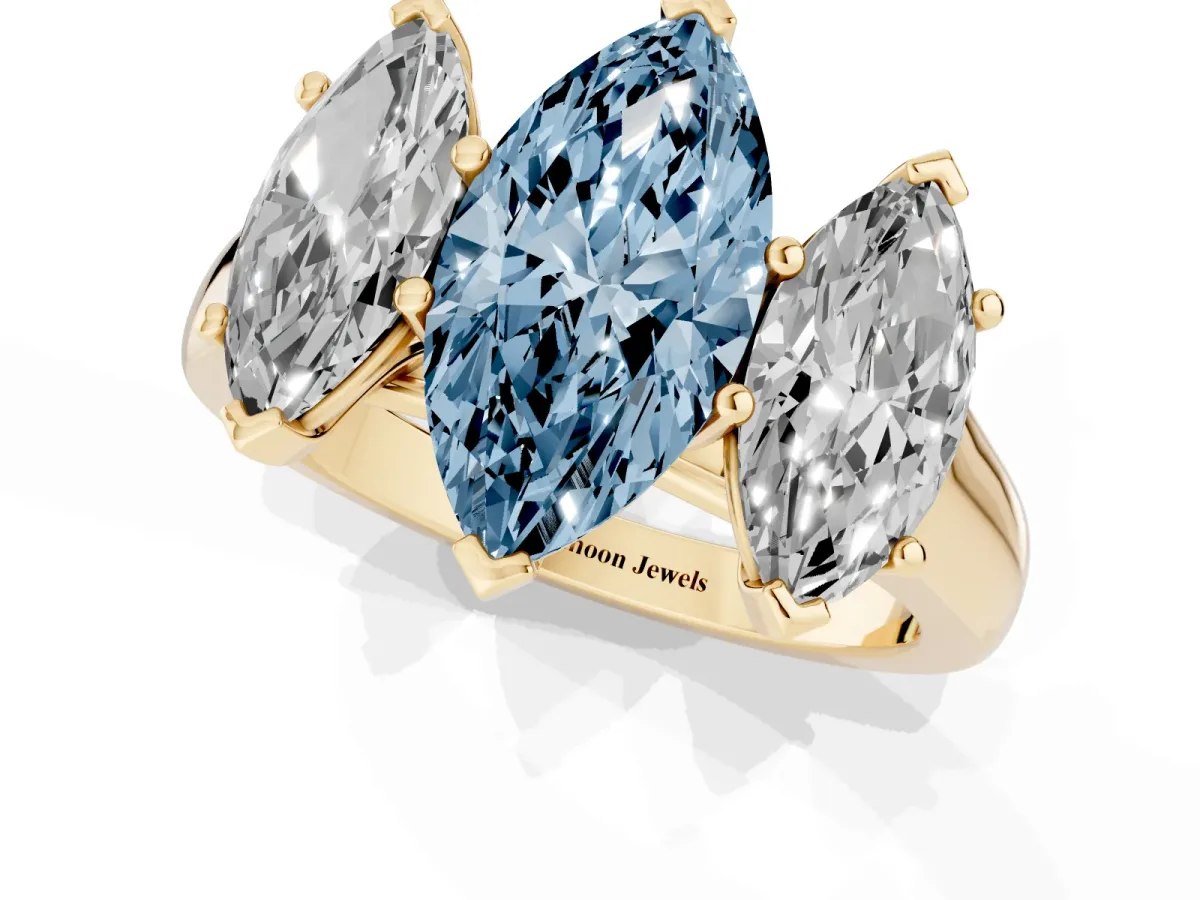 Fancy Blue Marquise Cut Three-Stone Diamond Ring with Prong Setting on a Classic Band Yellow gold