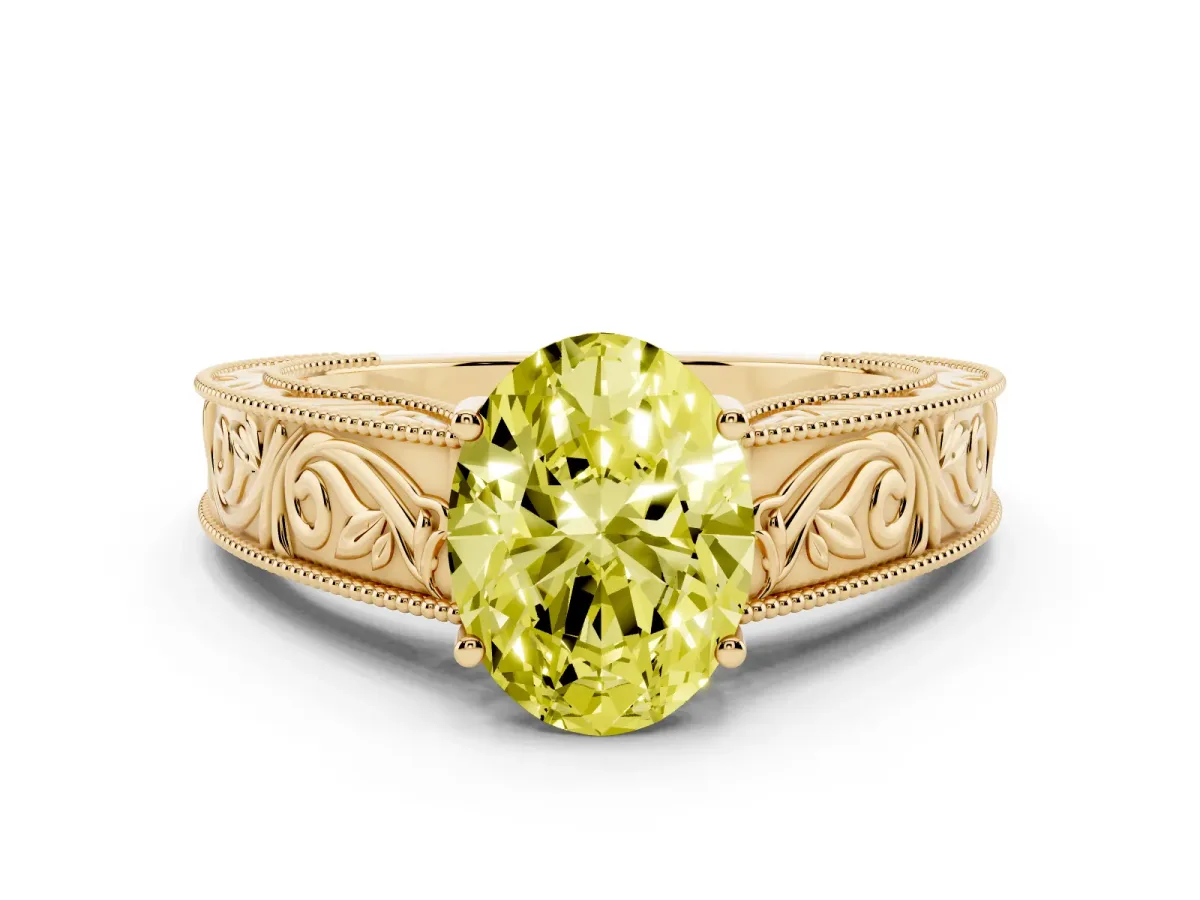 Fancy Yellow Oval Cut Diamond Solitaire Ring with Engraved Band and Four-Prong Setting Yellow gold