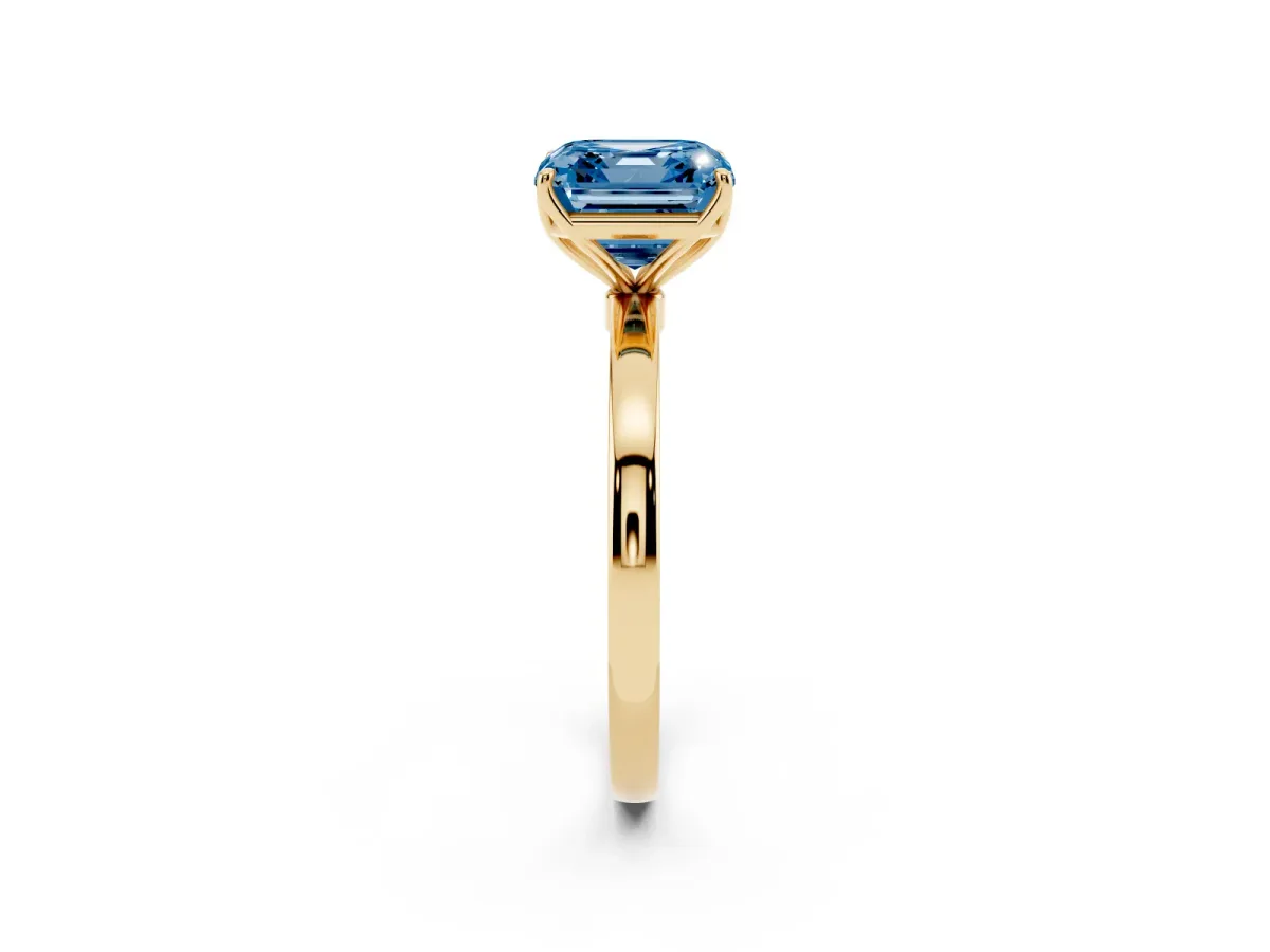 Fancy Blue Asscher Cut Diamond Solitaire Ring with Thin Band and Prong Setting Yellow gold