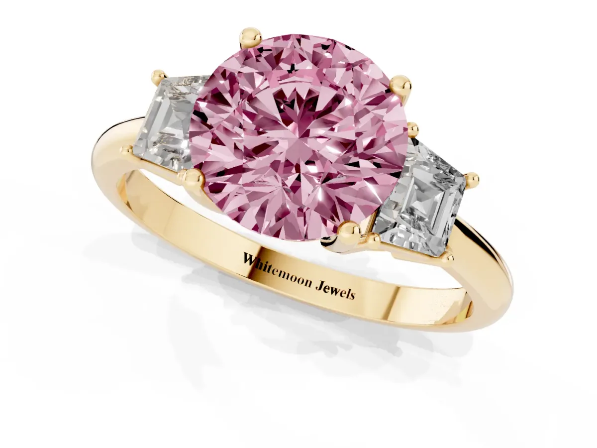 Fancy Pink Round Cut Diamond Three-Stone Ring with Trapezoid Side Stones and Prong Setting Yellow gold