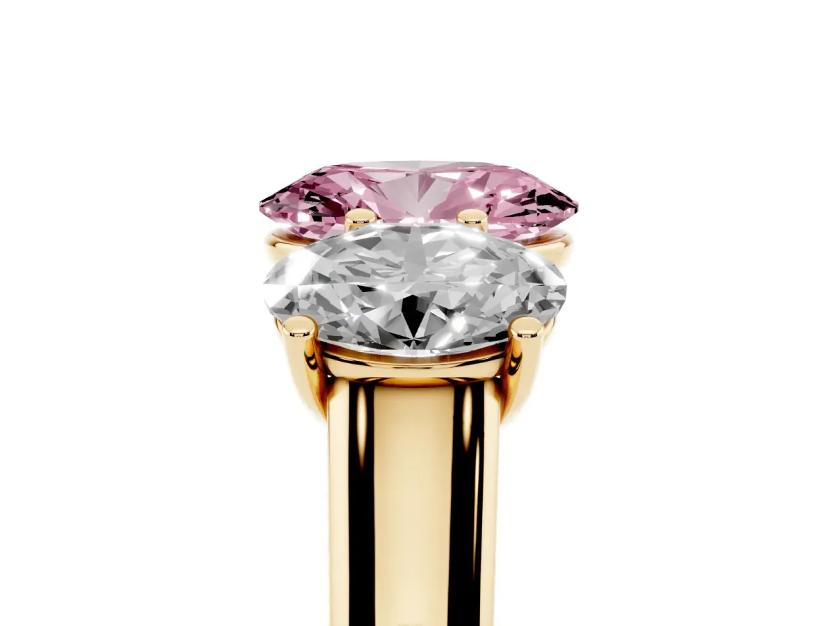 Fancy Pink Oval Cut Three-Stone Diamond Ring with Prong Setting on a Classic Band Yellow gold