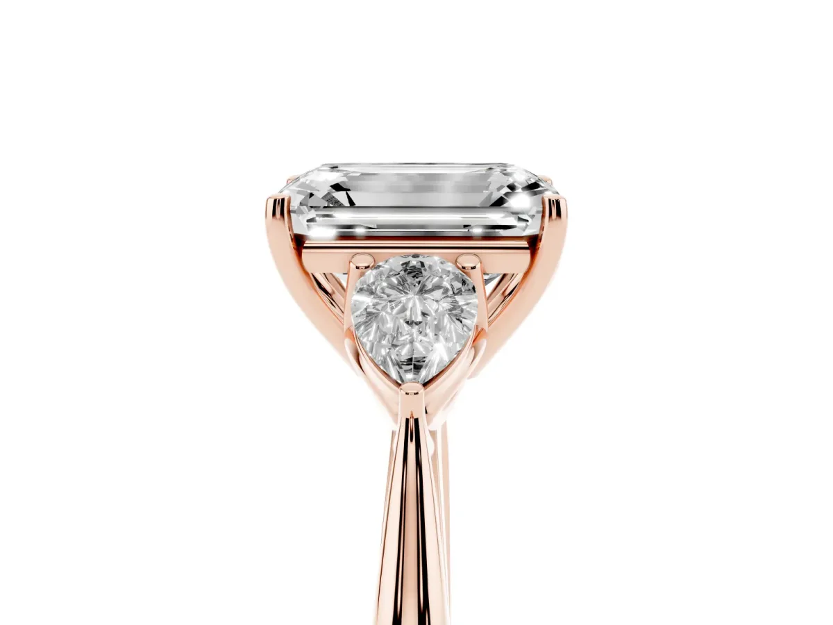 Three-Stone Emerald Cut Diamond Ring with Pear Side Stones in Four-Prong Setting Rose gold