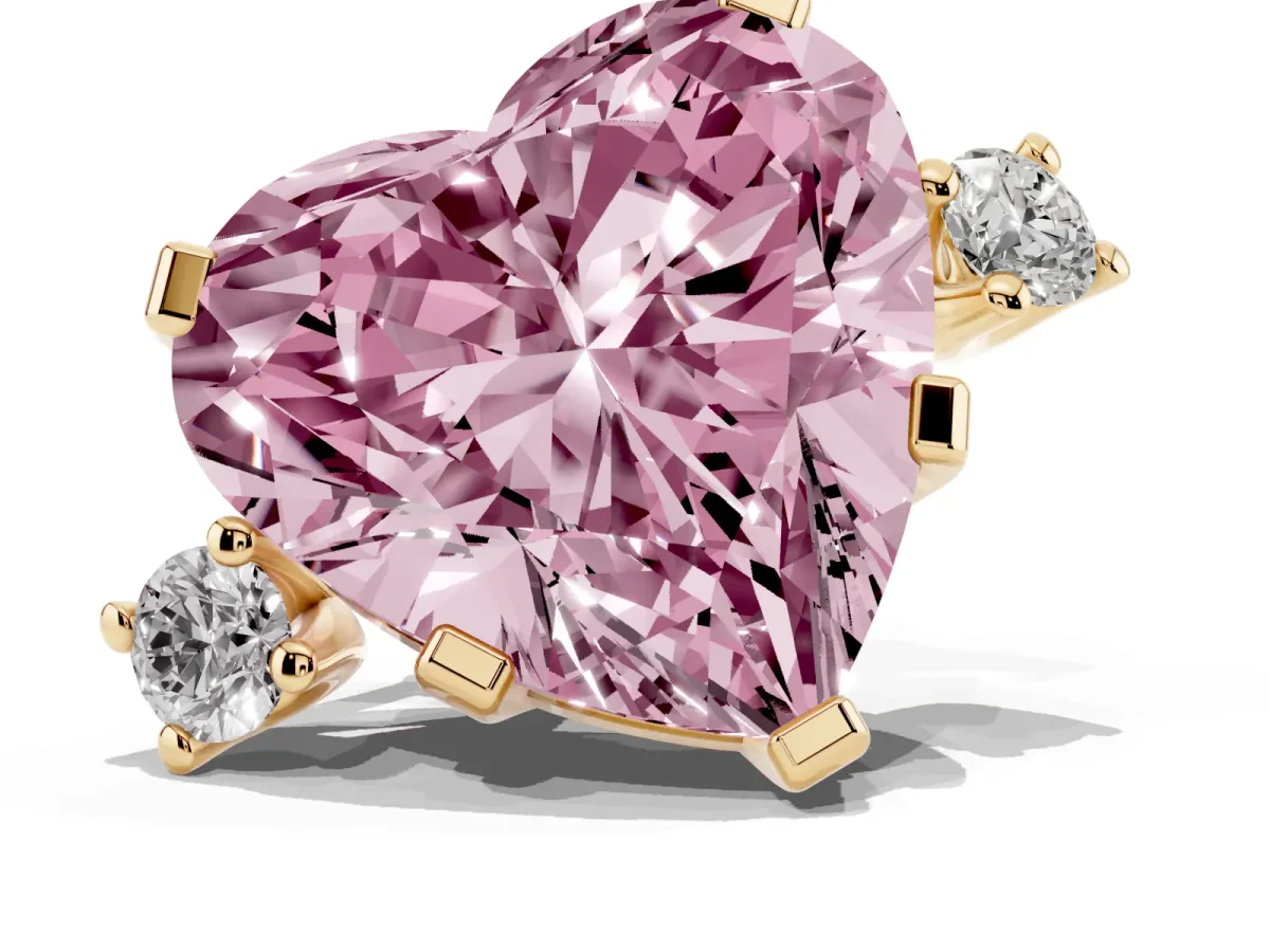 Fancy Pink Heart Cut Cut Three-Stone Solitaire Ring with Round Accent Diamonds and Four-Prong Setting Yellow gold