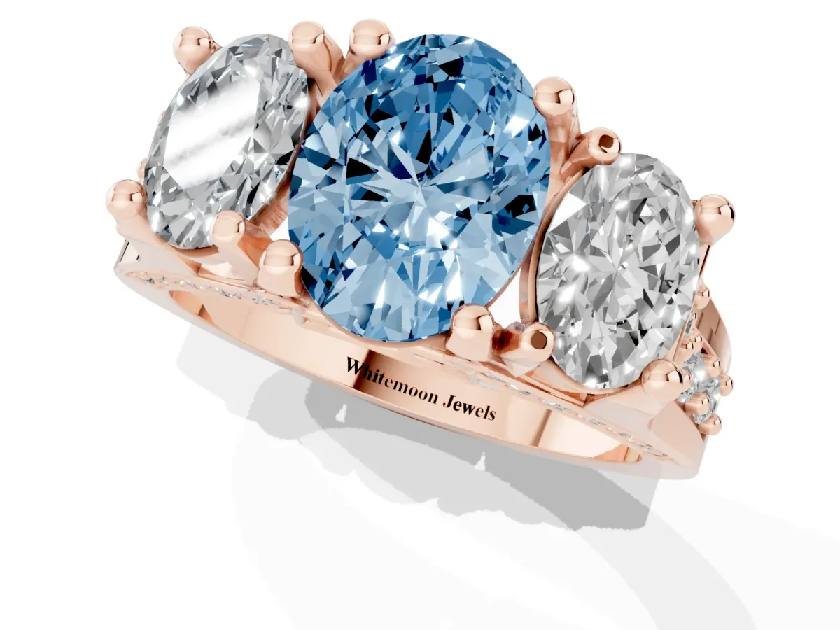 Fancy Blue Oval Cut Diamond Three-Stone Ring with Channel Set Band and Four-Prong Setting Rose gold