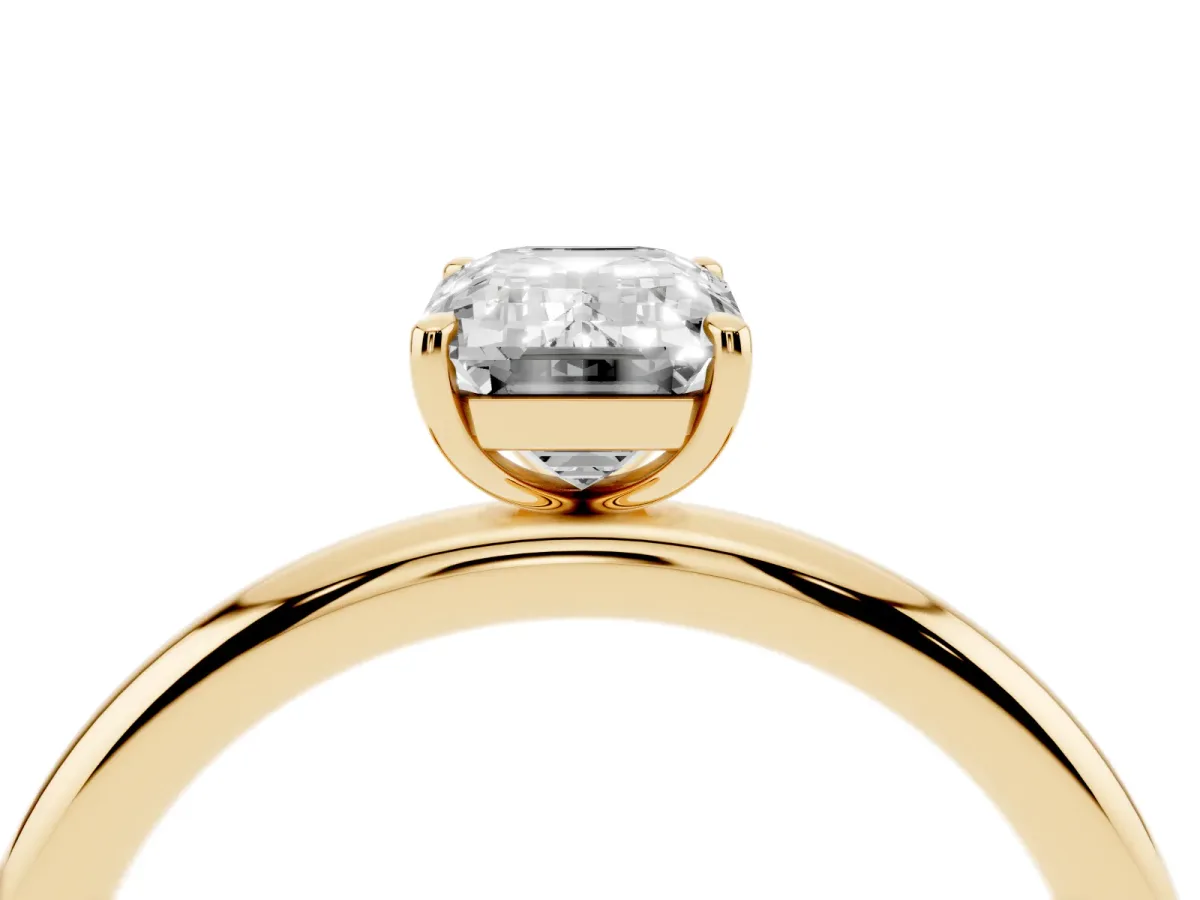 Emerald Cut Solitaire Diamond Ring with Four-Prong Setting on a Plain Band Yellow gold