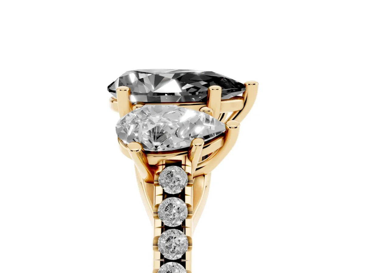 Fancy Black Three-Stone Pear Cut Diamond Ring with Round Pavé Band and Prong Setting Yellow gold