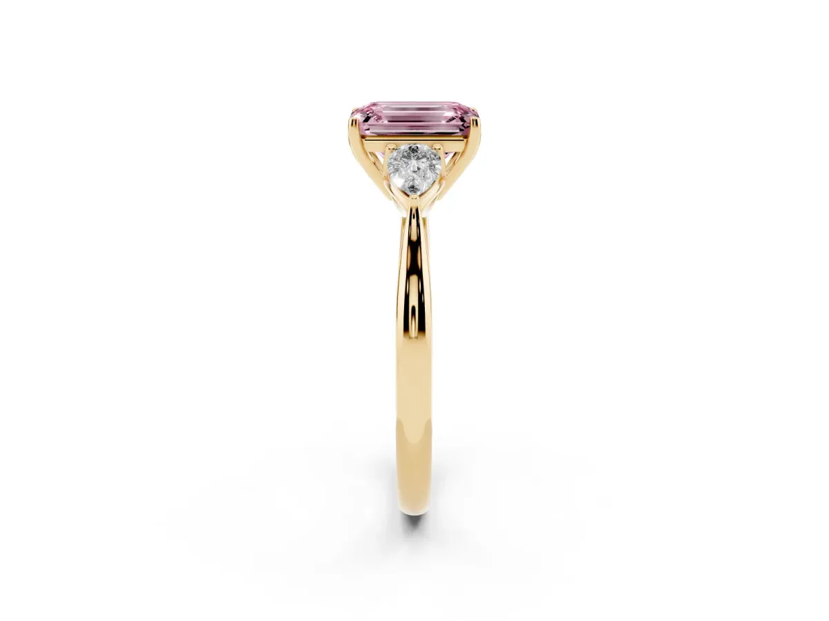 Fancy Pink Three-Stone Emerald Cut Brilliant Diamond Solitaire Ring with Tapered Band and Four-Prong Setting Yellow gold
