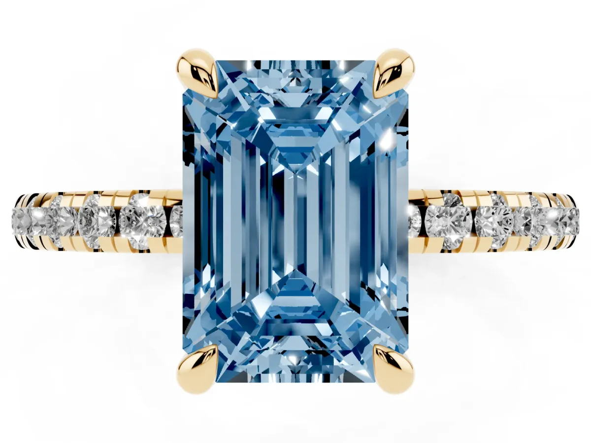 Fancy Blue Emerald Cut Diamond Brilliant Solitaire Ring with Pavé Band and Four-Prong Setting Yellow gold