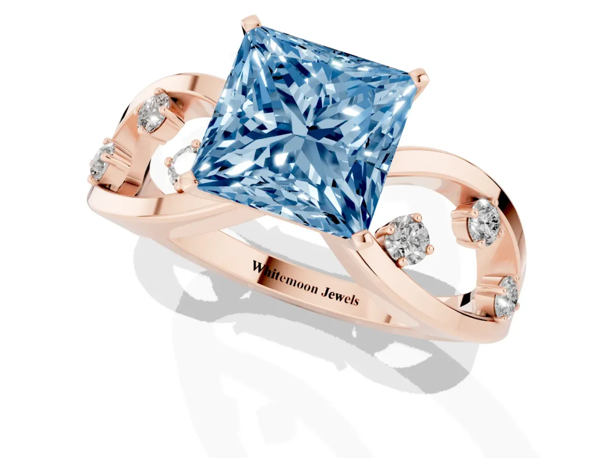 Fancy Blue Princess Cut Cut Solitaire Diamond with Side Stones on Criss-Cross Band and Four-Prong Setting Rose gold
