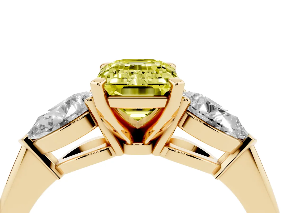 Fancy Yellow Three-Stone Emerald Cut Diamond Ring with Pear Side Stones and Four-Prong Setting Yellow gold