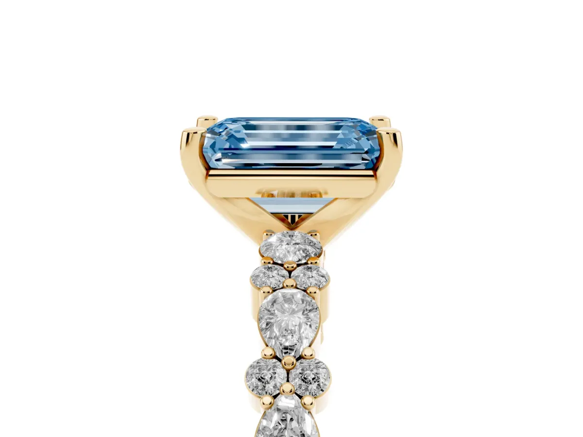 Fancy Blue Emerald Cut Diamond Side Stone Solitaire Ring with Round and Four-Prong Setting Yellow gold