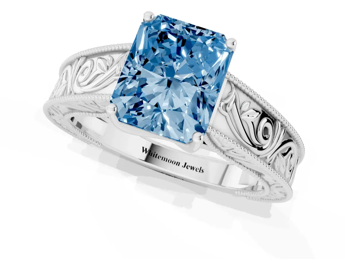 Fancy Blue Radiant Cut Diamond Solitaire Ring with Engraved Band and Four-Prong Setting White gold