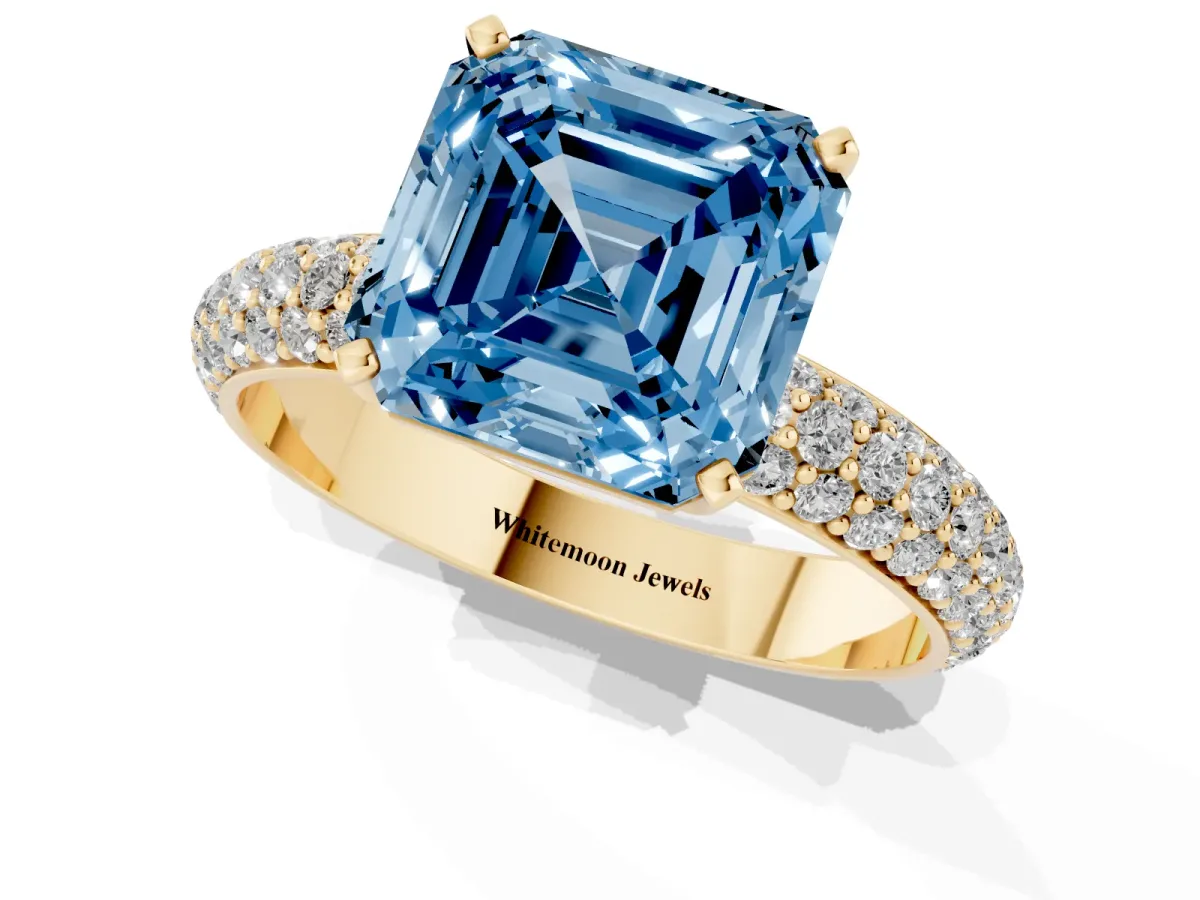 Fancy Blue Asscher Cut Diamond Solitaire Ring with Prong Setting and Pavé Band Yellow gold