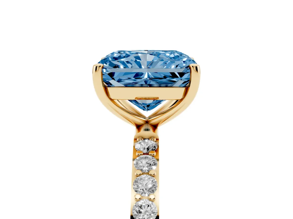 Fancy Blue Radiant Cut Diamond Solitaire Ring with Round Pavé Shoulders and Prong Setting Yellow gold