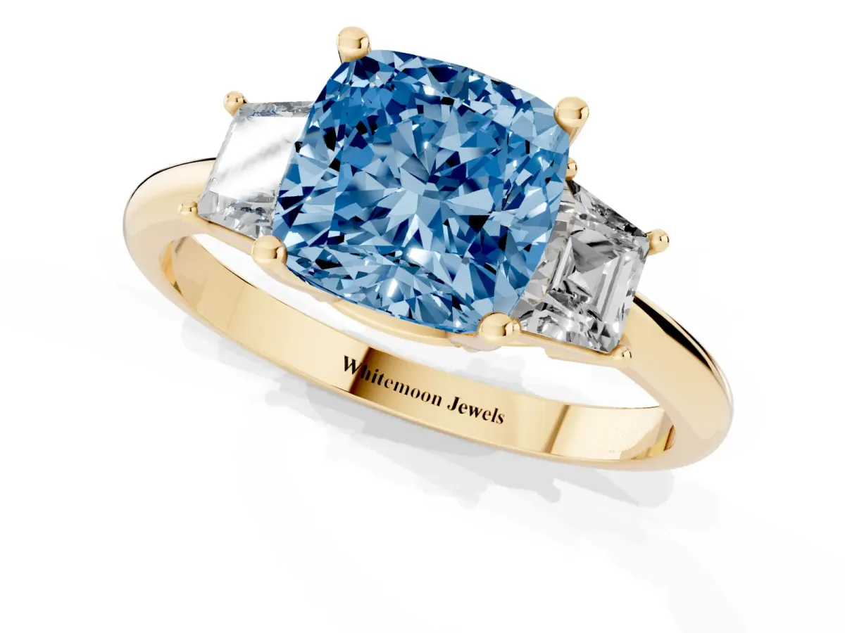 Fancy Blue Cushion Cut Diamond Three-Stone Ring with Trapezoid Side Stones and Prong Setting Yellow gold