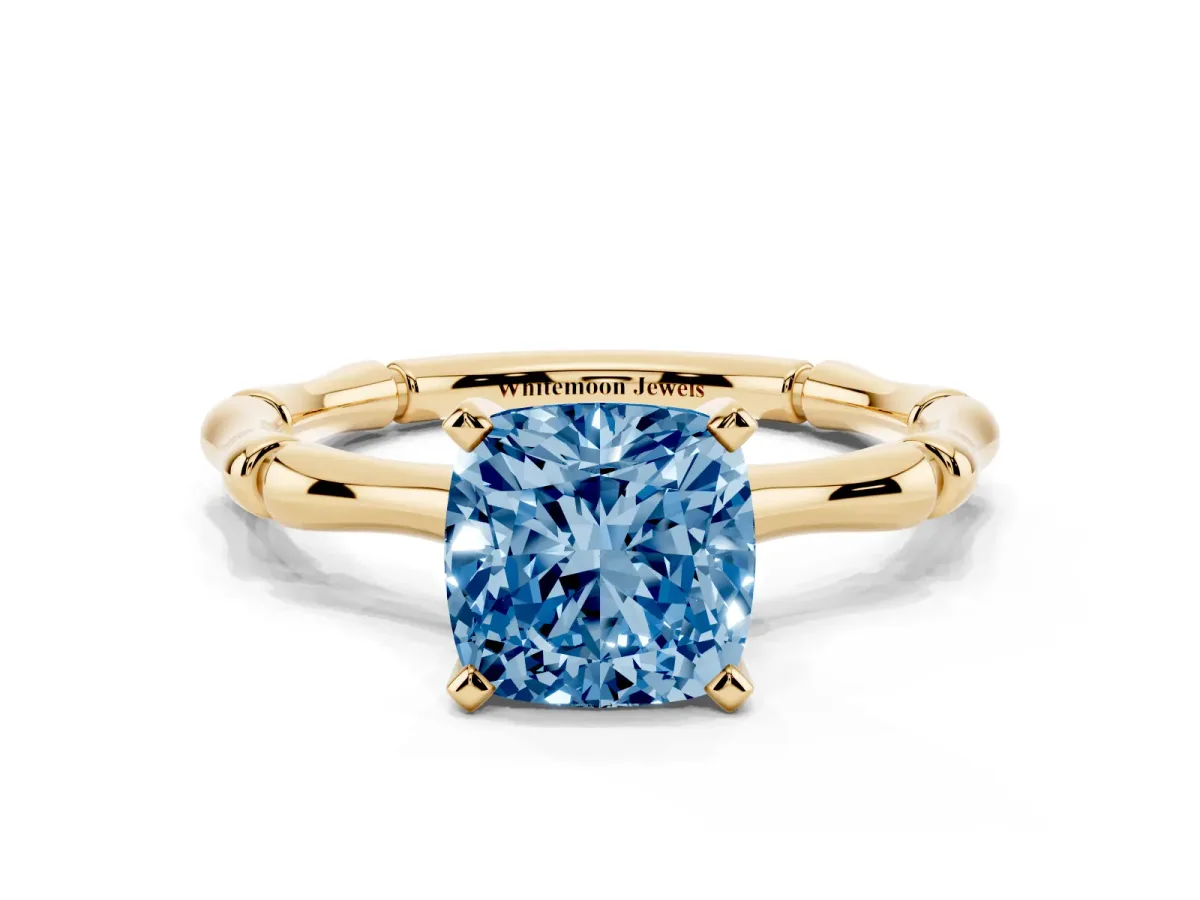 Fancy Blue Cushion Cut Solitaire Diamond Ring with Bamboo Band and Four-Prong Setting Yellow gold