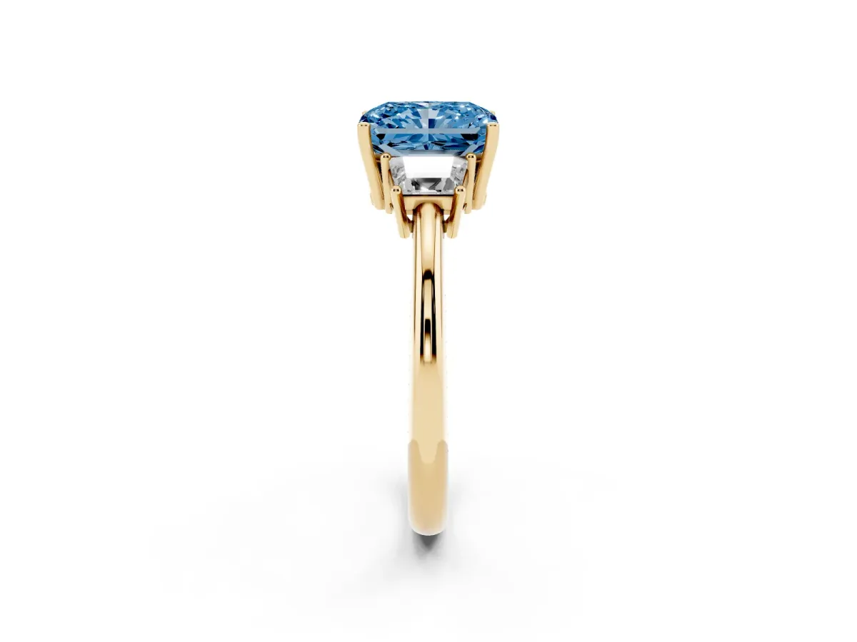 Fancy Blue Radiant Cut Diamond Three-Stone Ring with Trapezoid Side Stones and Prong Setting Yellow gold