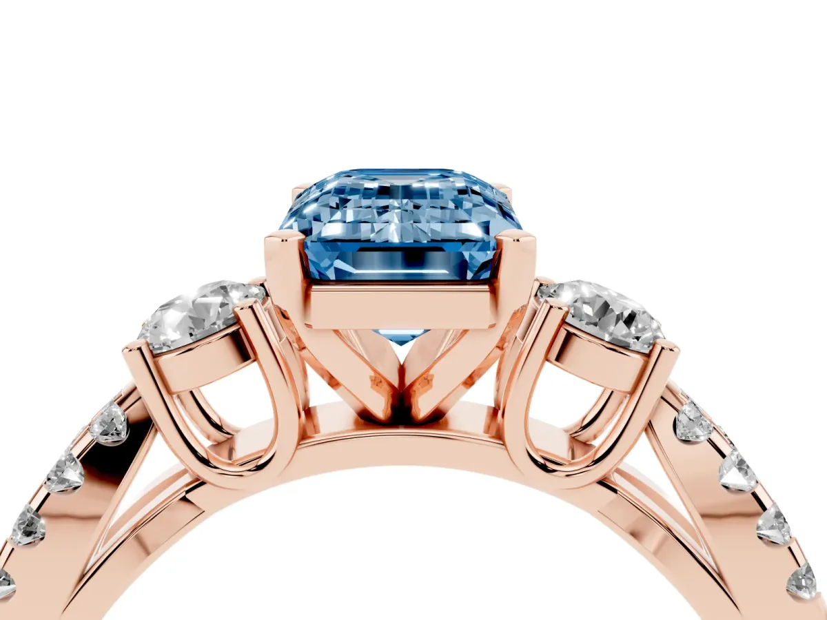 Fancy Blue Emerald Cut Diamond Three-Stone Ring with Pavé Split Shank and Four-Prong Setting Rose gold