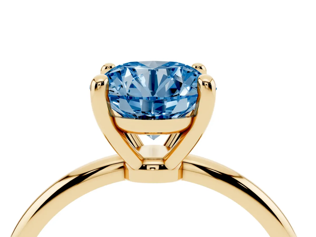 Fancy Blue Round Cut Solitaire Diamond Ring with 4-Prong Setting on a Classic Band Yellow gold