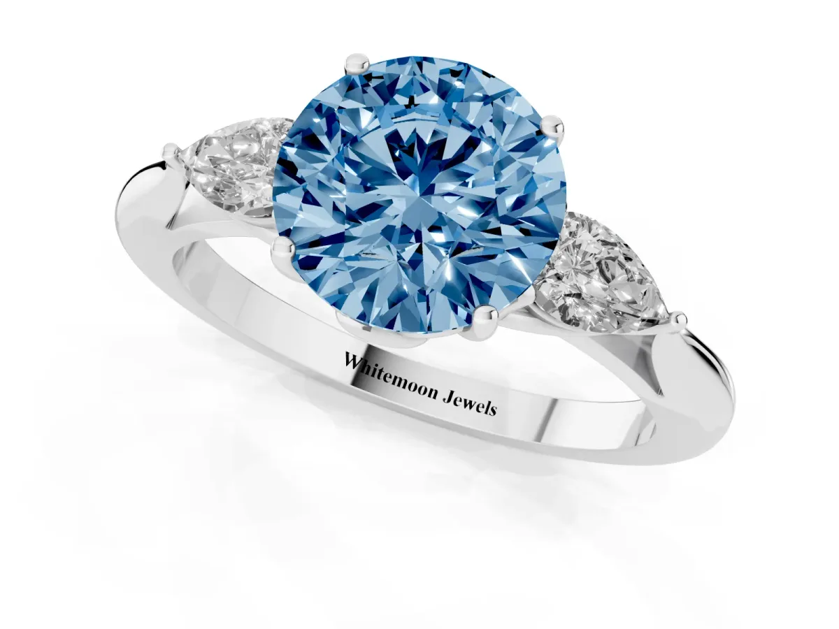 Fancy Blue Three-Stone Round Cut Diamond Ring with Pear Side Stones in Four-Prong Setting Silver