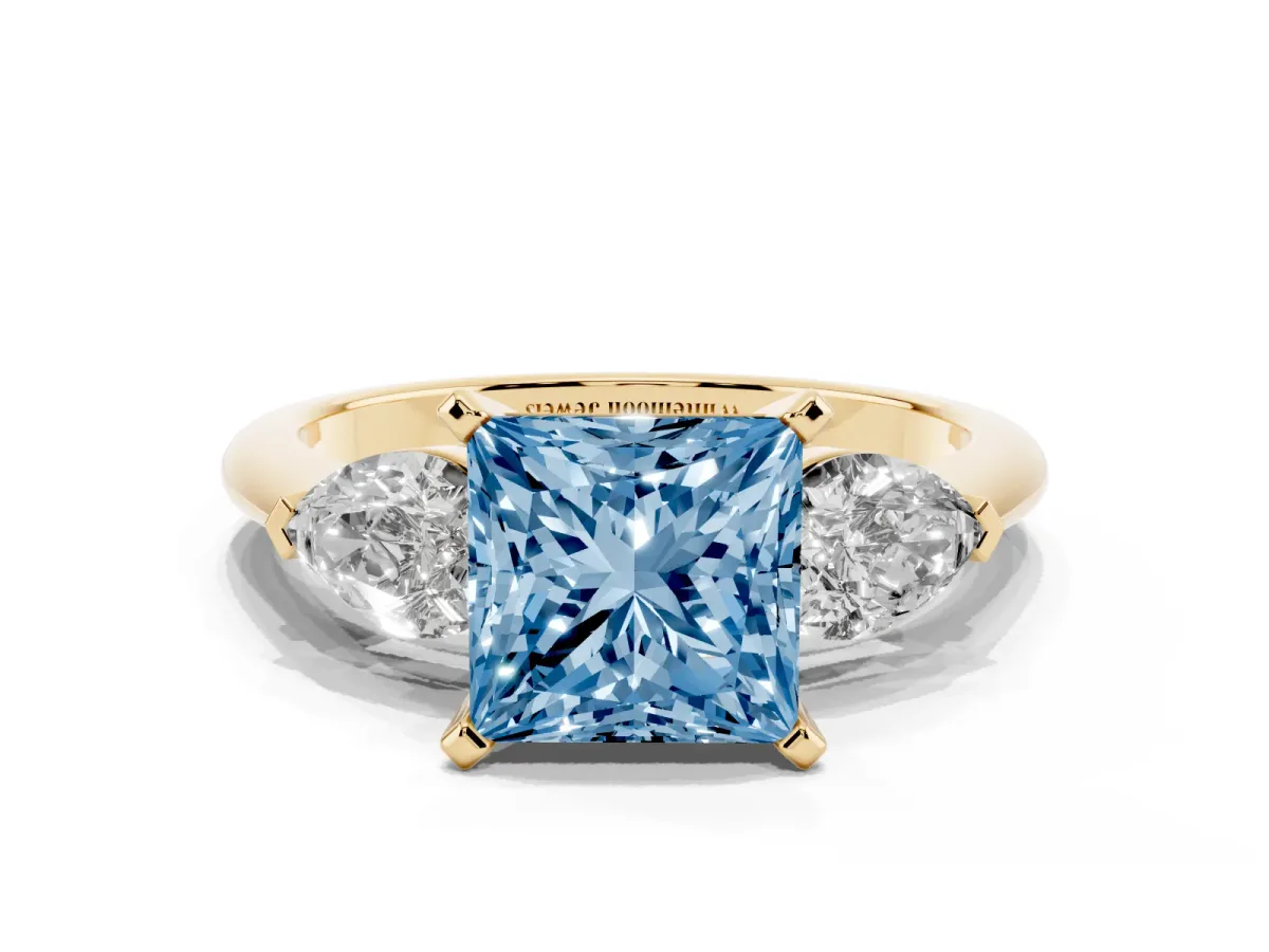 Fancy Blue Three-Stone Princess Cut Diamond Ring with Pear Side Stones and Four-Prong Setting Yellow gold