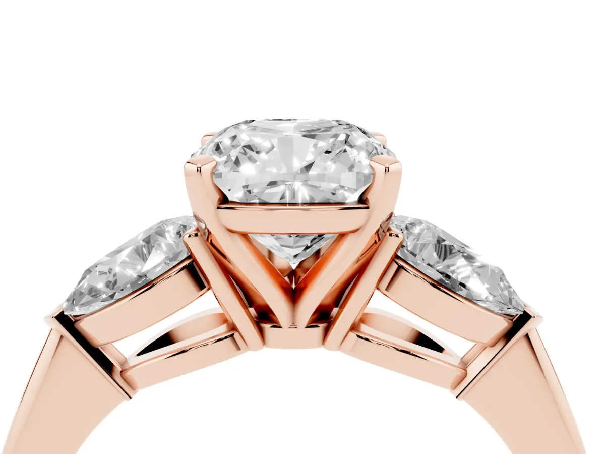 Three-Stone Cushion Cut Diamond Ring with Pear Side Stones and Four-Prong Setting Rose gold